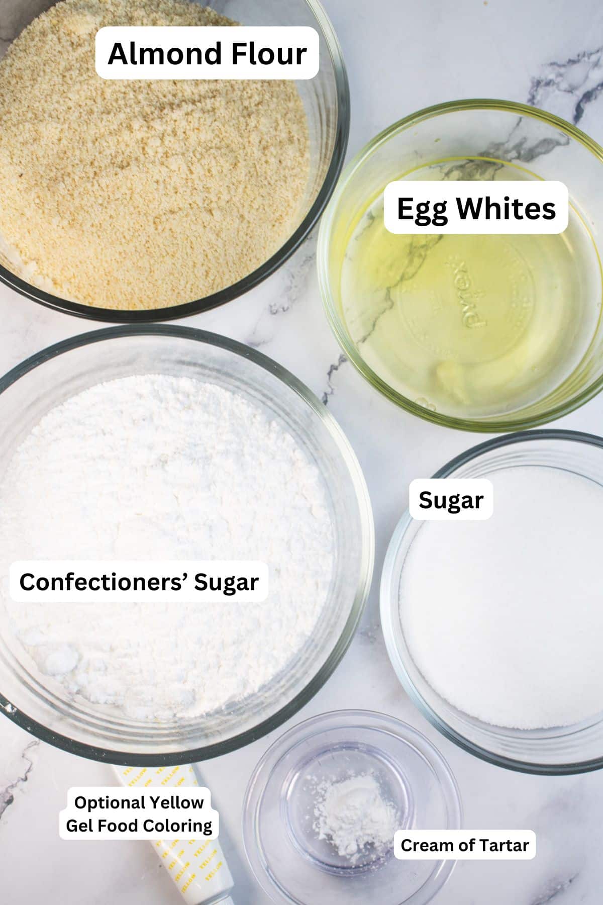 Lemon macaron shells ingredients measured and labeled for easy baking.