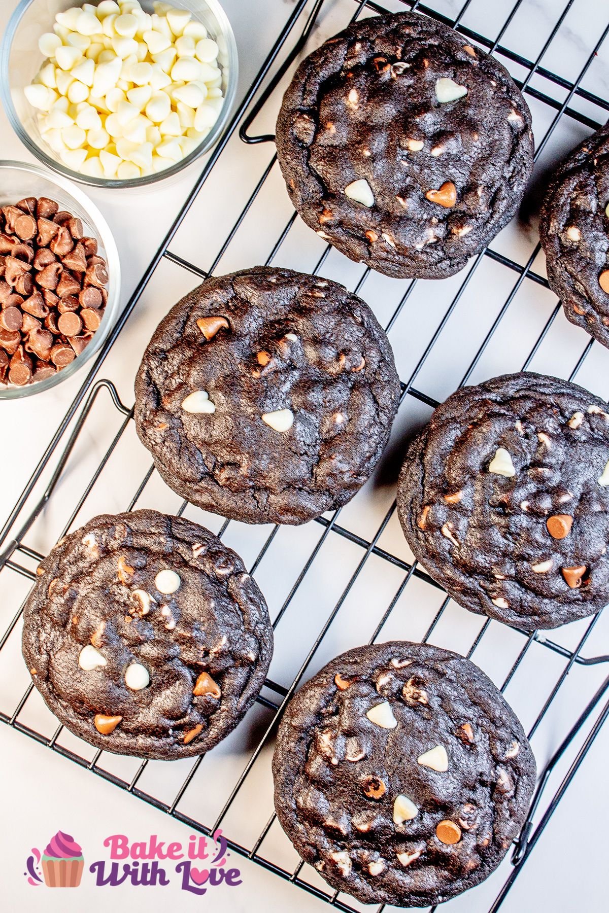 Tasty Levain Bakery copycat black and white chocolate chip cookies on a wire cooling rack with bowl of the chocolate morsels on the side.