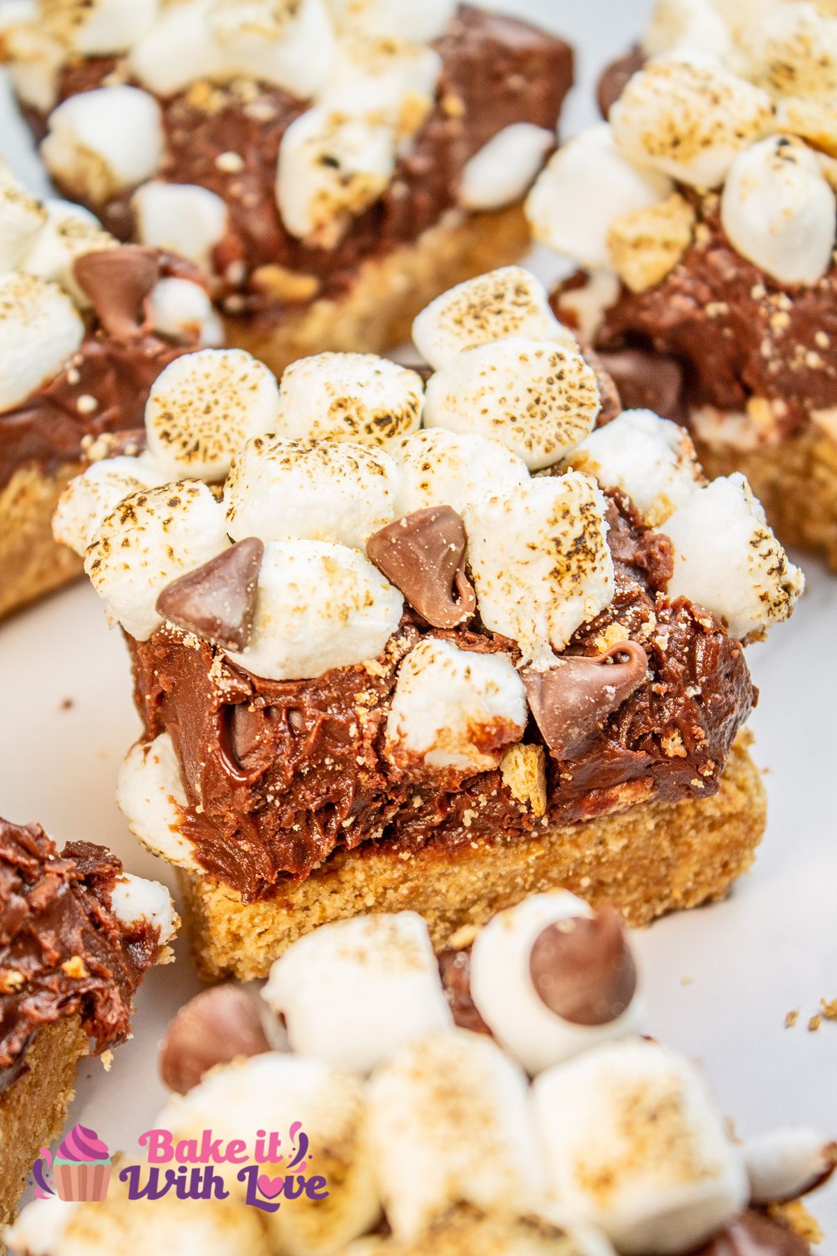 Randomly arranged cut squares of the s'mores fudge from an angled overhead view.