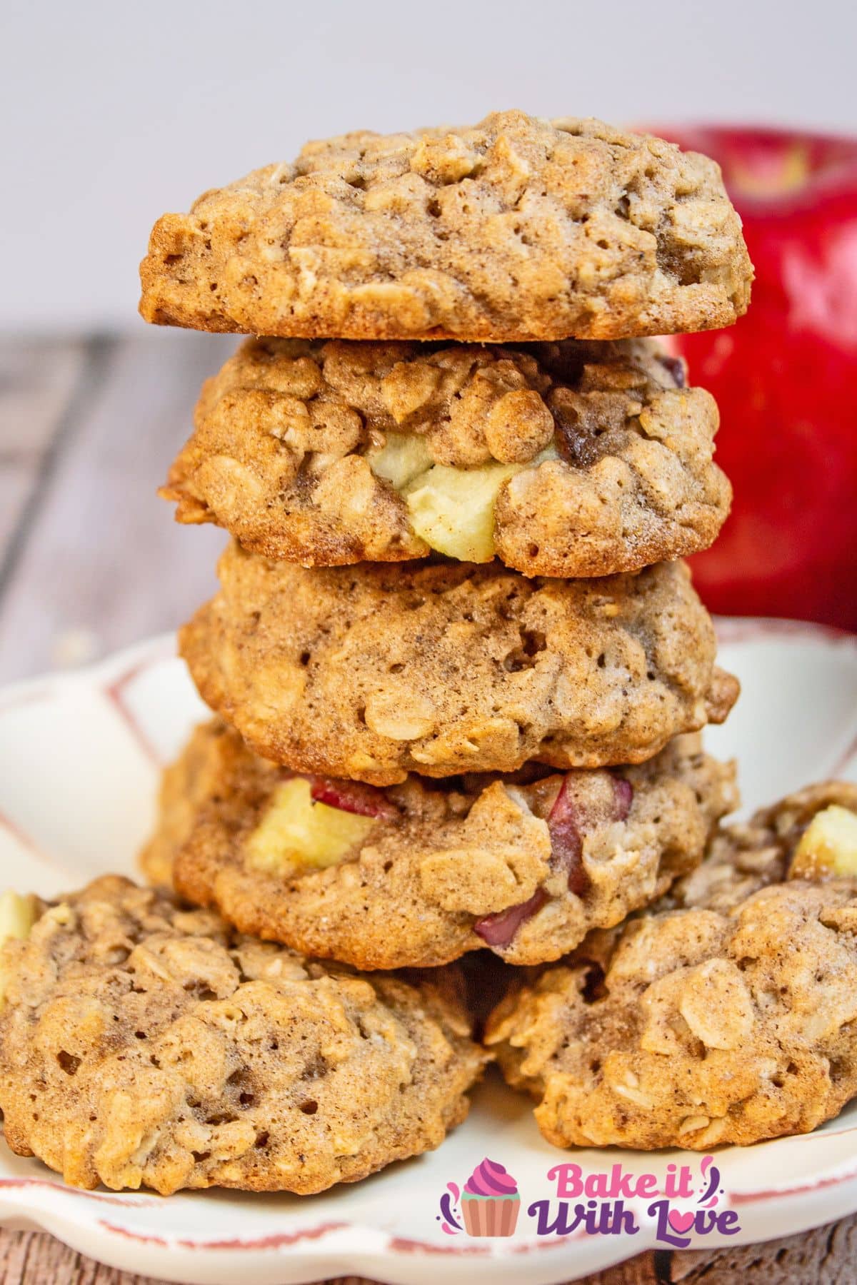 Tall image of the stacked apple oatmeal cookies on a small dessert plate.