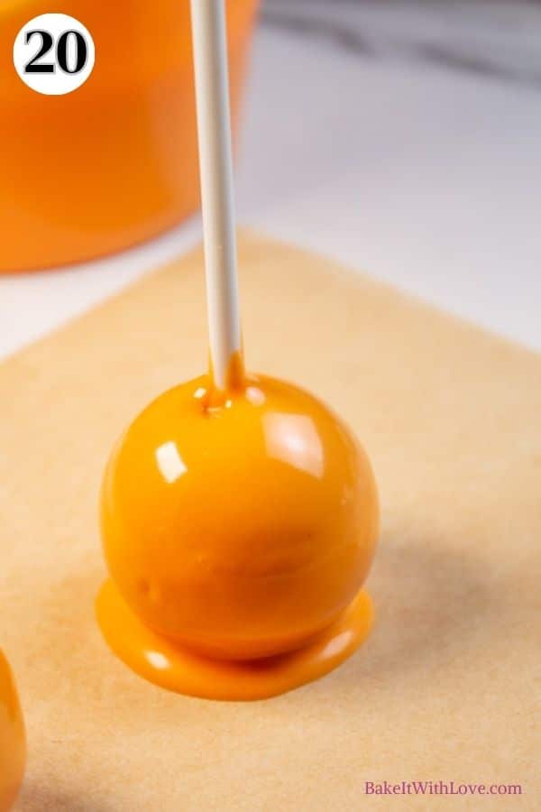 Halloween cake pops process photo 20 make Jack-o-lantern trick-or-treat basket by placing the coated cake pop on a sheet of parchment paper.