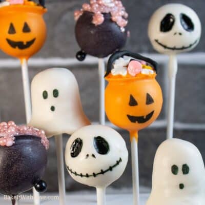 Halloween cake pops in 4 designs - a jack-o-lantern treat-or-treat basket, a witch's bubbling cauldron, a white ghost, and Jack Skellington.