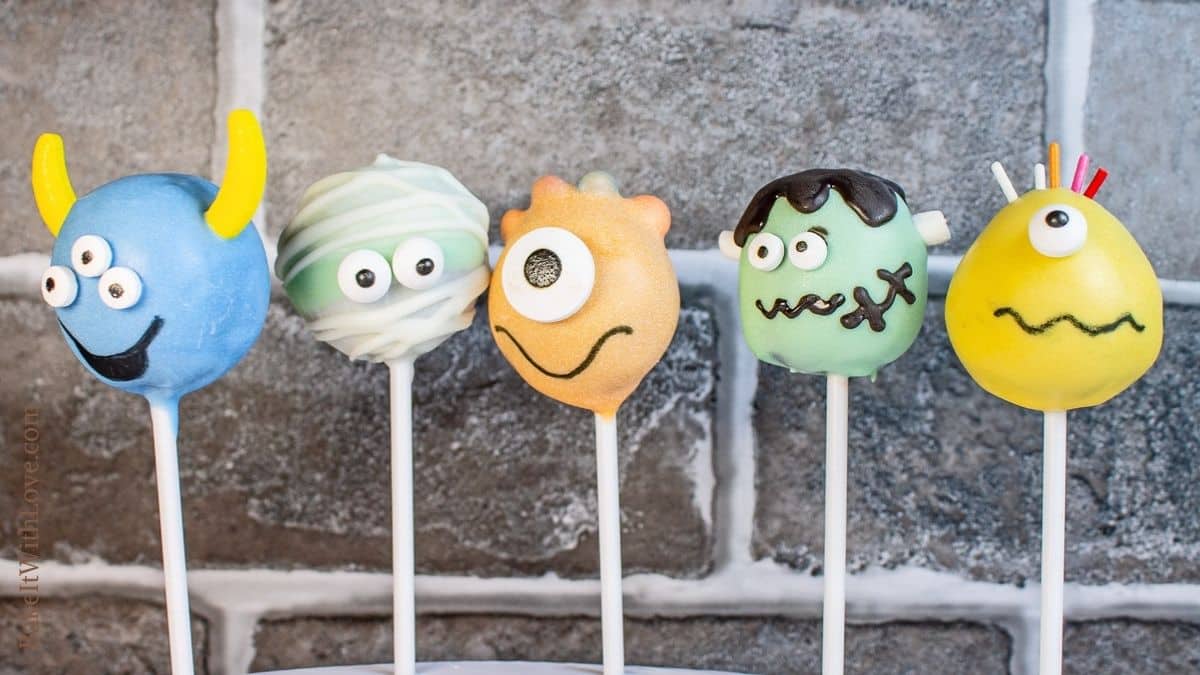 All 5 Halloween monster cake pop designs side by side on brick background.