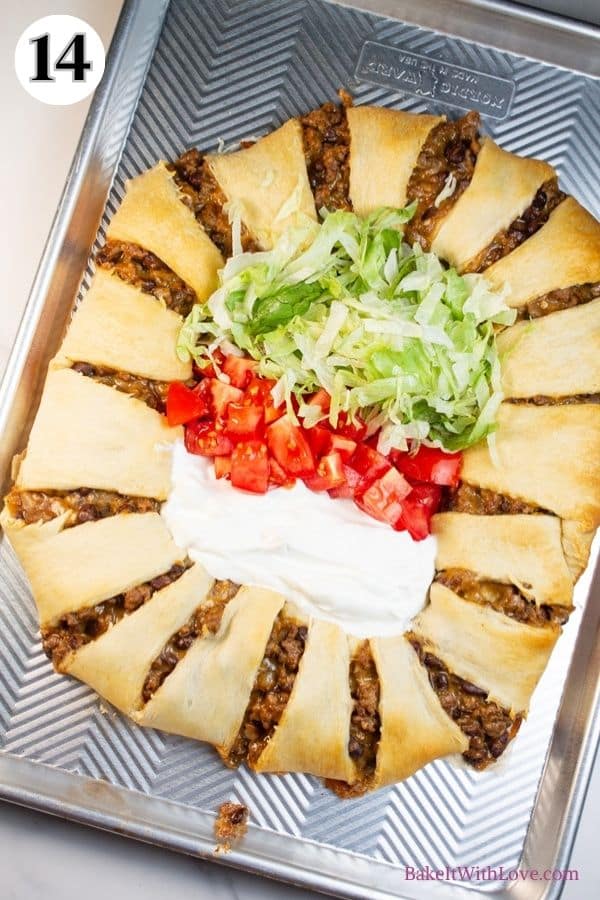 Spider taco ring process photo 14 assembled taco ring on a baking sheet with taco toppings in the center.