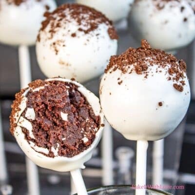 Square image showing cookies & cream cake pops with one having a bite taken out of it.