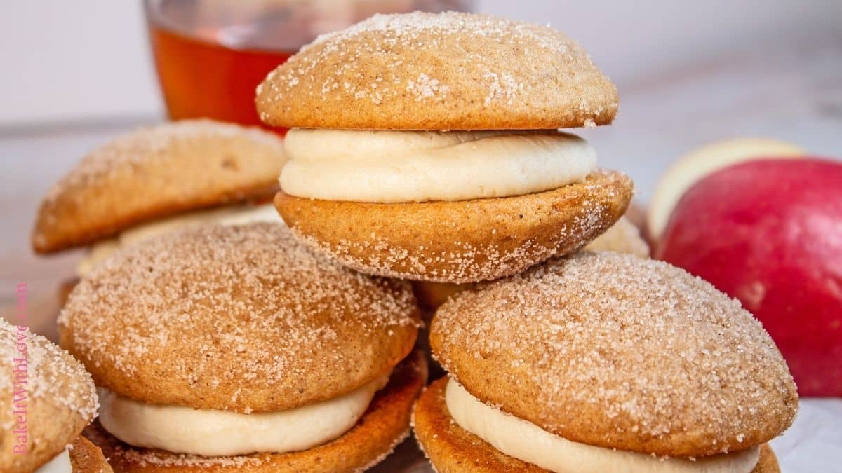 Wide image of stacked apple cider whoopie pies.