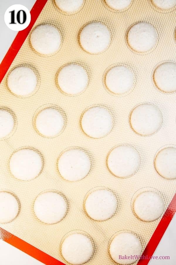 Apple pie macarons process photo 10 showing baked macaron shells on a silicone baking mat. 