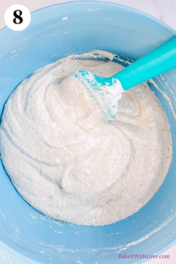 Apple pie macarons process photo 8 showing the mixed macaron batter in a mixing bowl with a silicone spatula sticking out. 