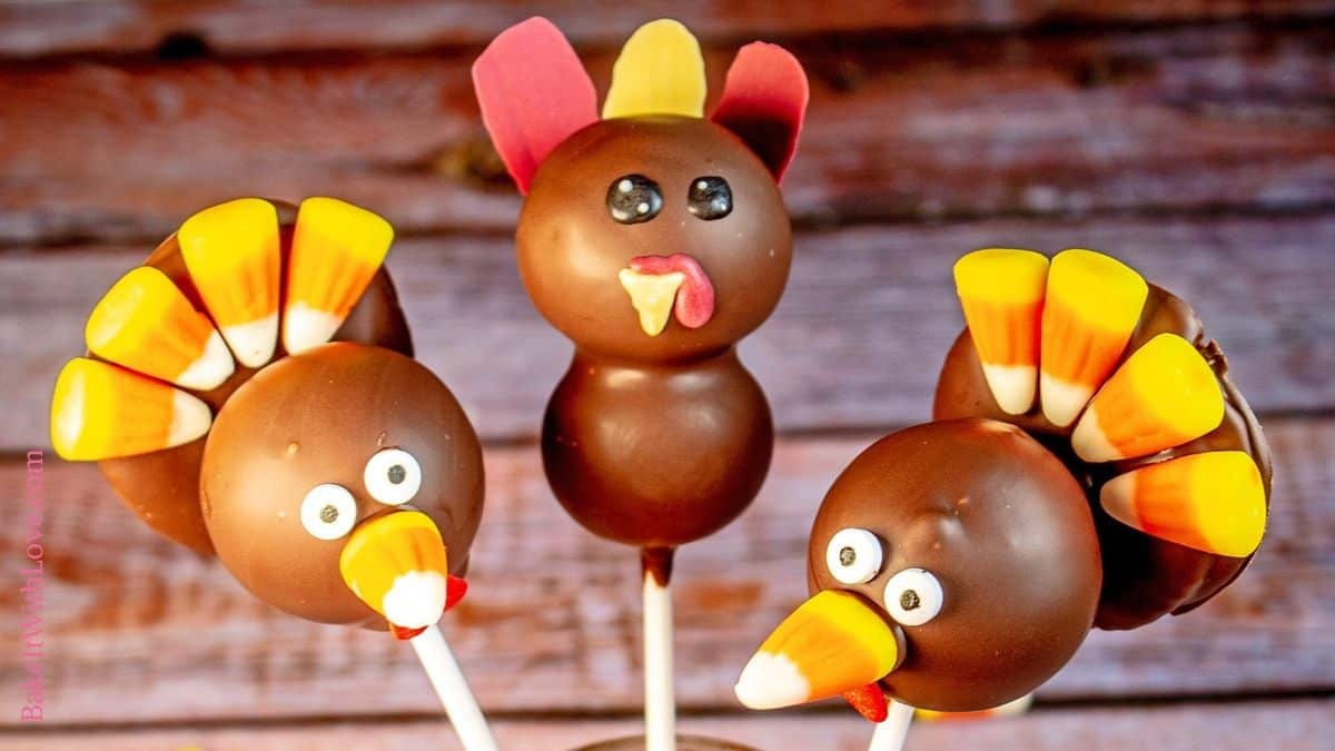 Wide image showing two candy corn turkey cake pops and one stacked turkey cake pop.