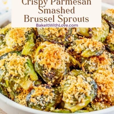 Crispy smashed parmesan brussel sprouts pin showing a bowl full of smashed brussel sprouts on a wooden surface with text.