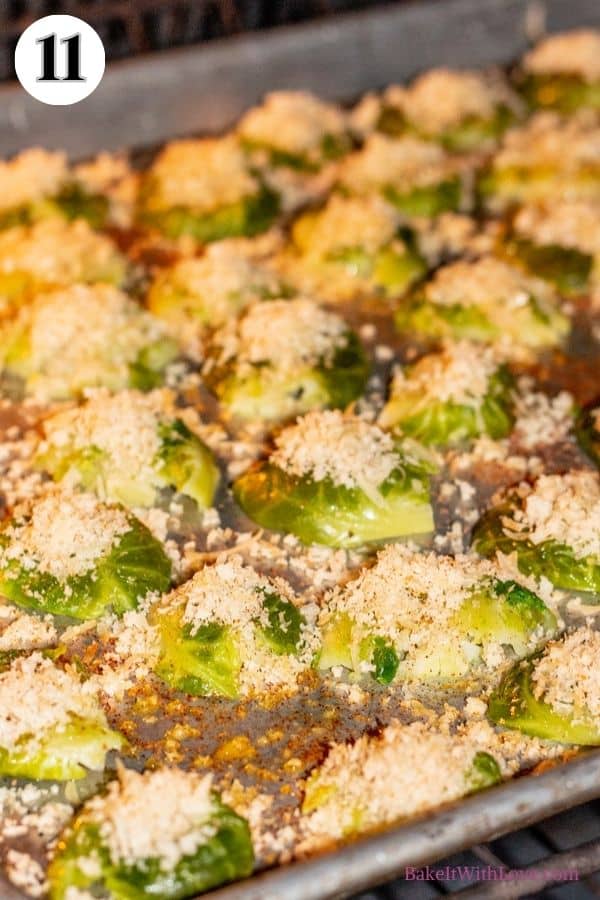 Crispy parmesan smashed brussel sprouts process photo 11 showing the smashed brussel sprouts baking in the oven on a baking sheet.