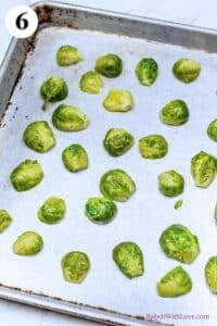 Crispy parmesan smashed brussel sprouts process photo 6 showing the steamed brussel sprouts spread out on the metal baking sheet.