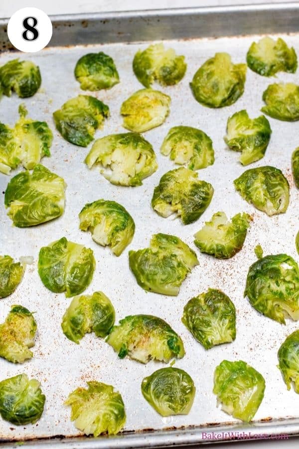 Crispy parmesan smashed brussel sprouts process photo 8 showing all of the smashed brussel sprouts on a baking sheet.