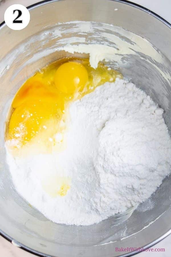 Grinch cookies process photo 2 showing butter, cake mix, eggs, and vanilla in a metal mixing bowl. 