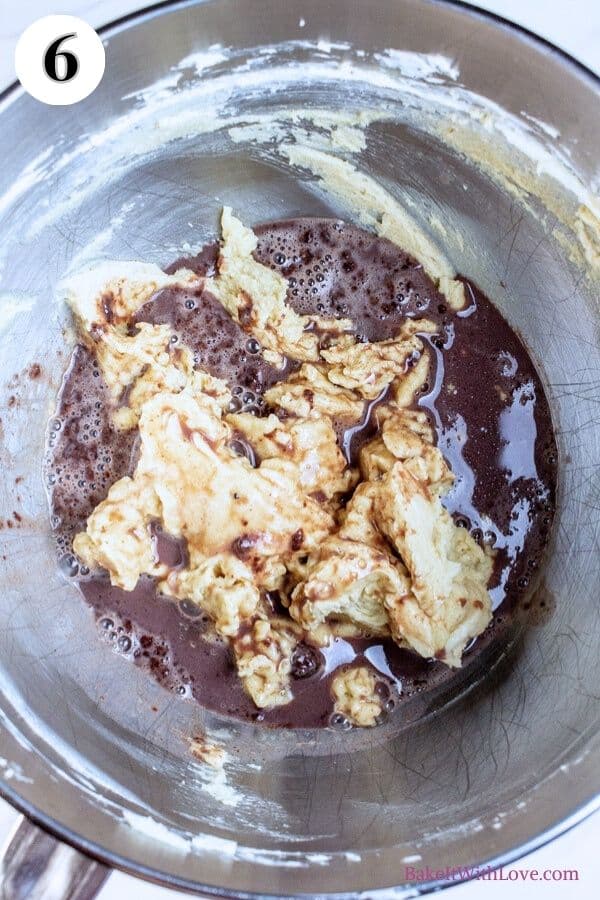 Hot chocolate cookies process photo 6 showing hot chocolate and dough in a metal mixing bowl. 