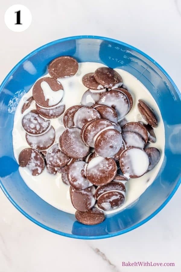 Mint chocolate macarons process photo 1 showing dark chocolate melting wafers and heavy cream in a mixing bowl.