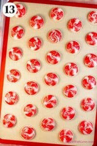 Peppermint macarons process photo 13 showing the baked macaron shells on a silicone baking mat.