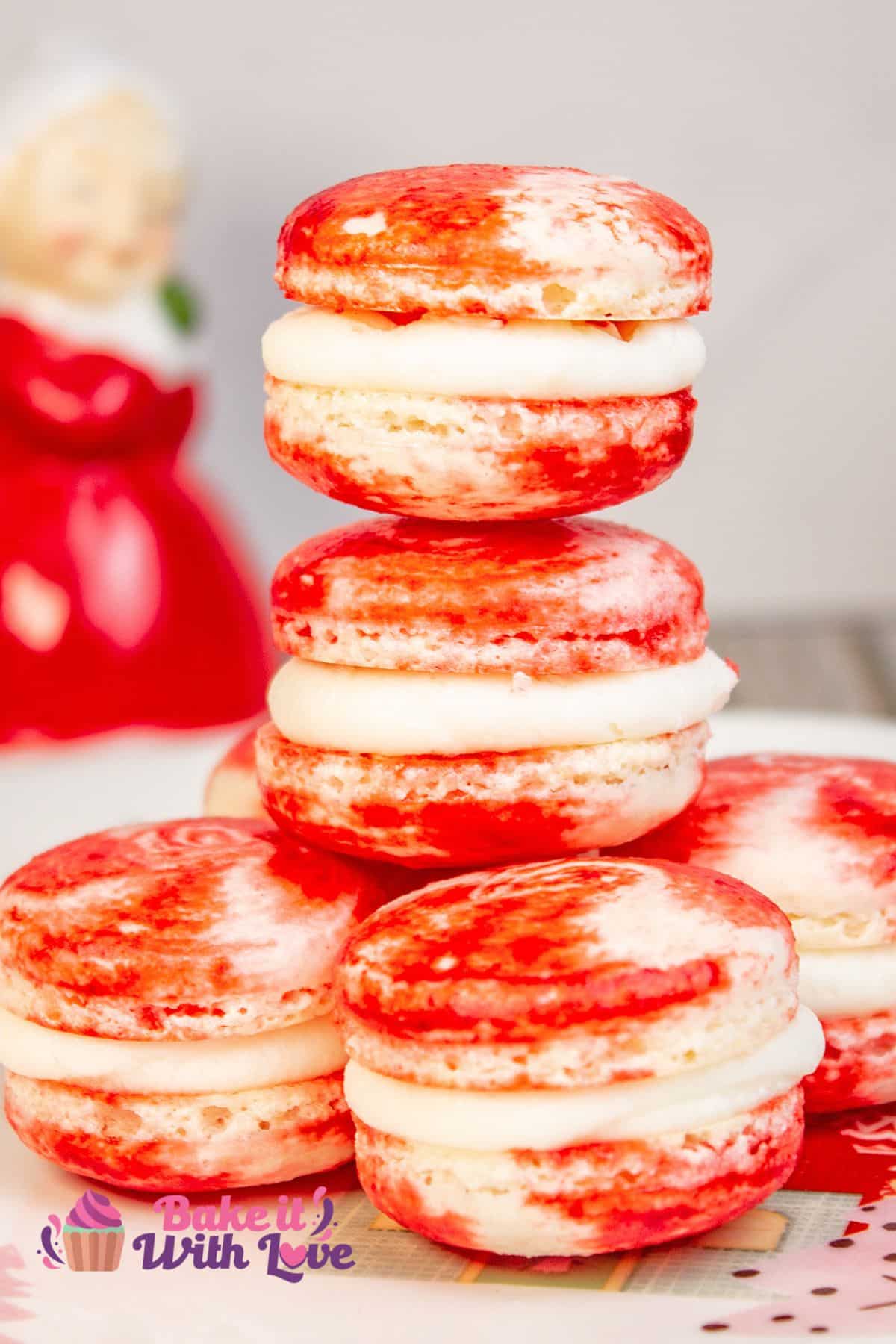 Tall image showing a tall stack of peppermint macarons on a plate with a Mrs. Claus salt shaker in the background.