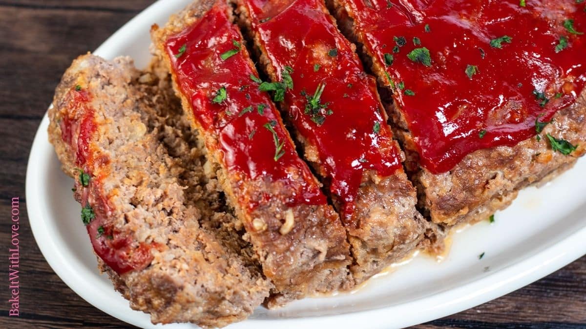 Horizontal image of Lipton onion soup meatloaf sliced and ready to serve on platter.