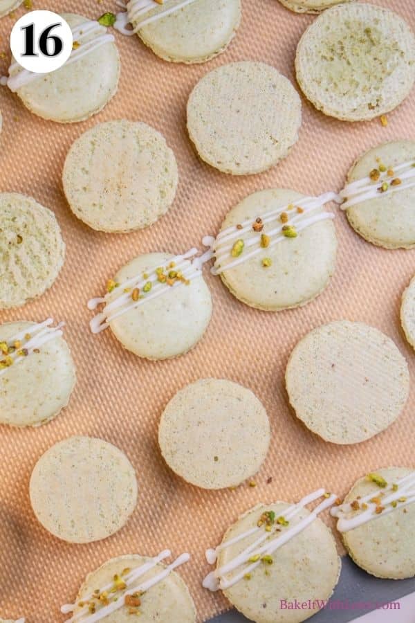 Pistachio macarons process photo 16 drizzle with optional white chocolate drizzle and sprinkle some crushed pistachios on the top shells.