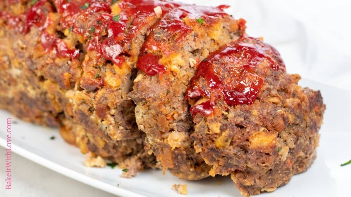 Wide image of sliced Stove Top Stuffing meatloaf on a white serving platter.