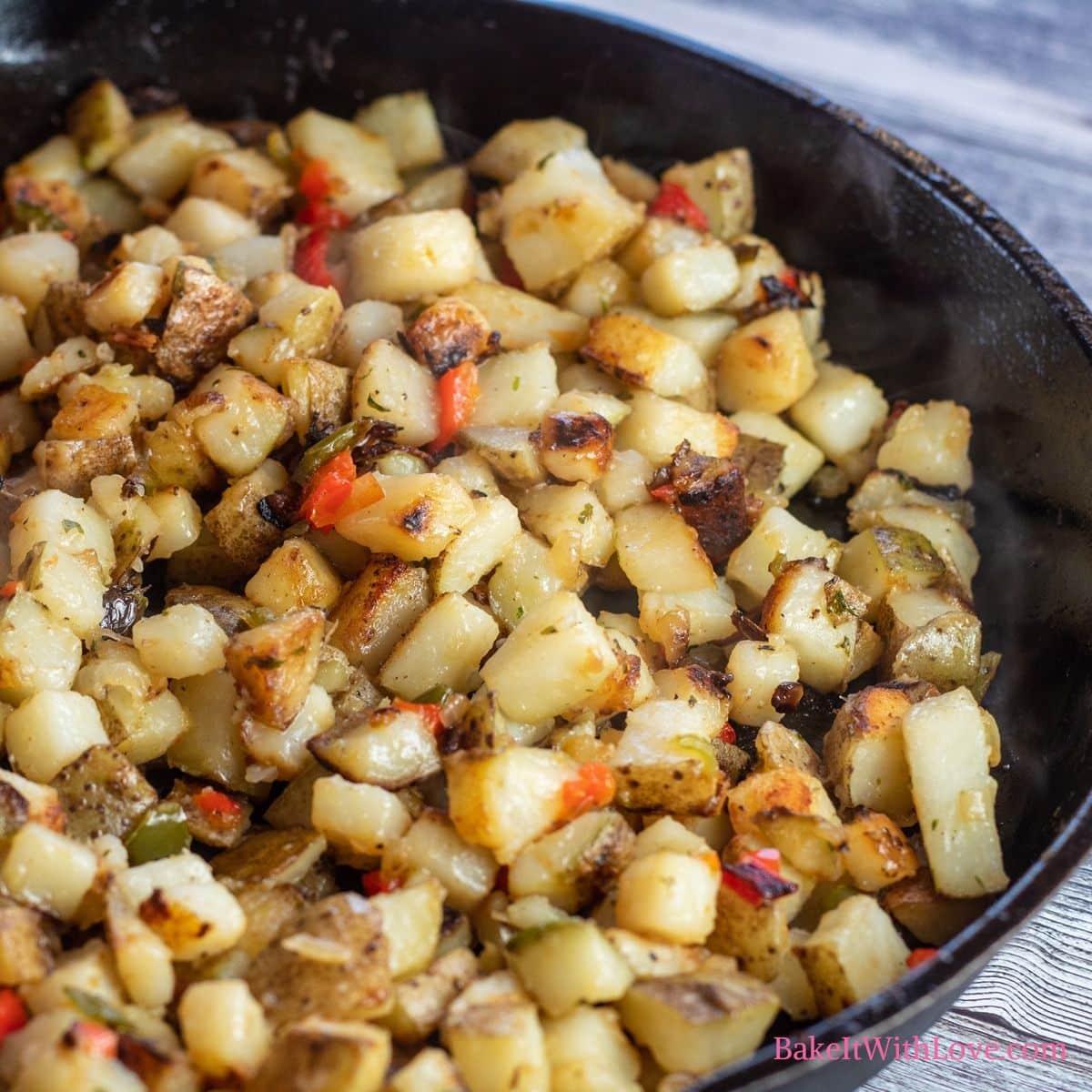 Square image of potatoes o Brien in a skillet.