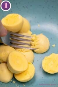 Jalapeno popper deviled eggs process photo 1 mash the egg yolks after slicing the hard boiled eggs in half lengthwise.