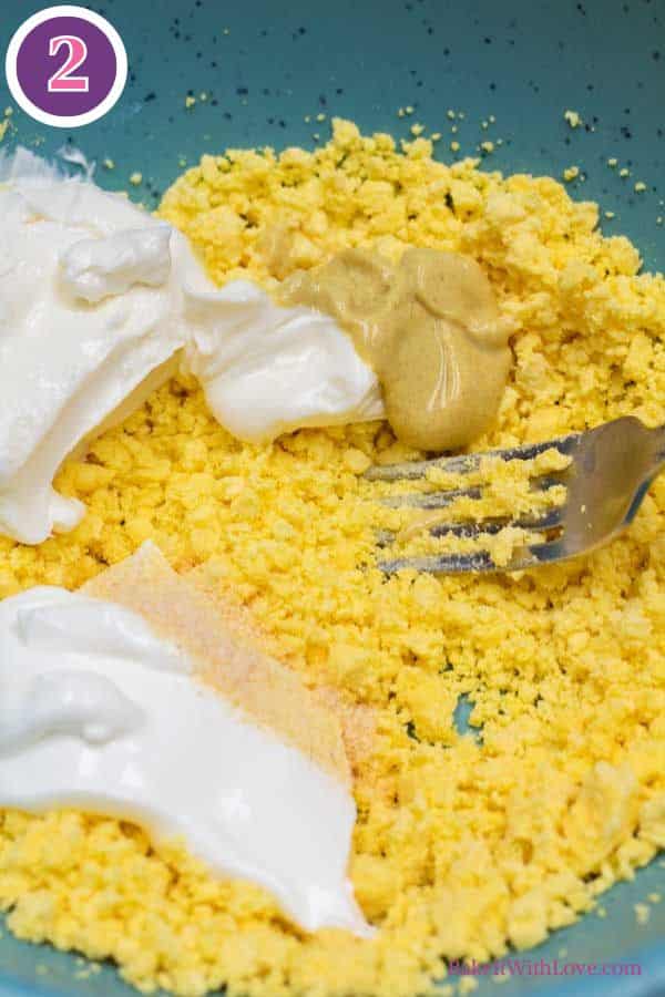 Jalapeno popper deviled eggs process photo 2 add the cream cheese, sour cream, Dijon, vinegar, and seasoning.