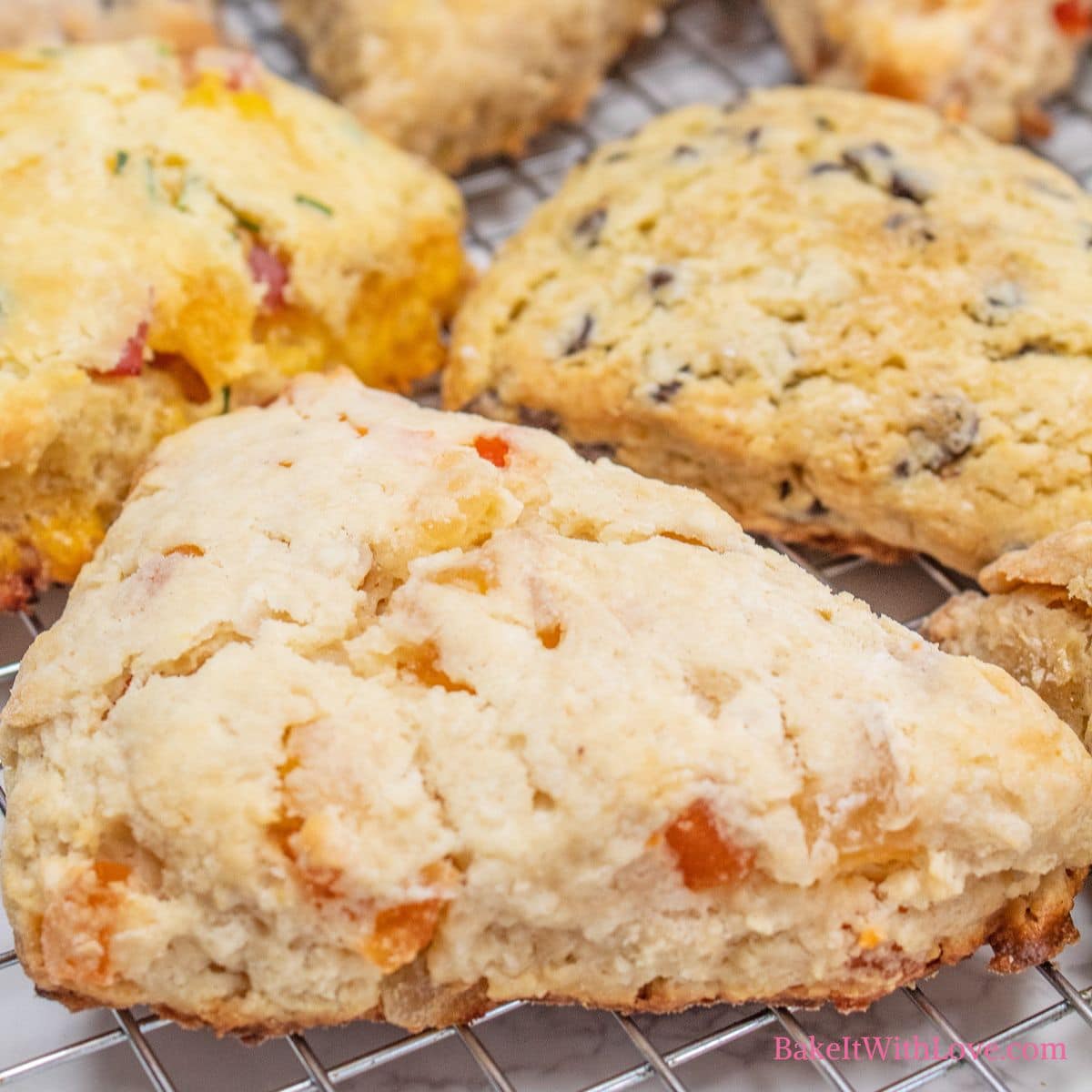 A delicious scones recipe that makes every flavor with only minor adjustments as shown by the 5 flavors on a cooling rack.