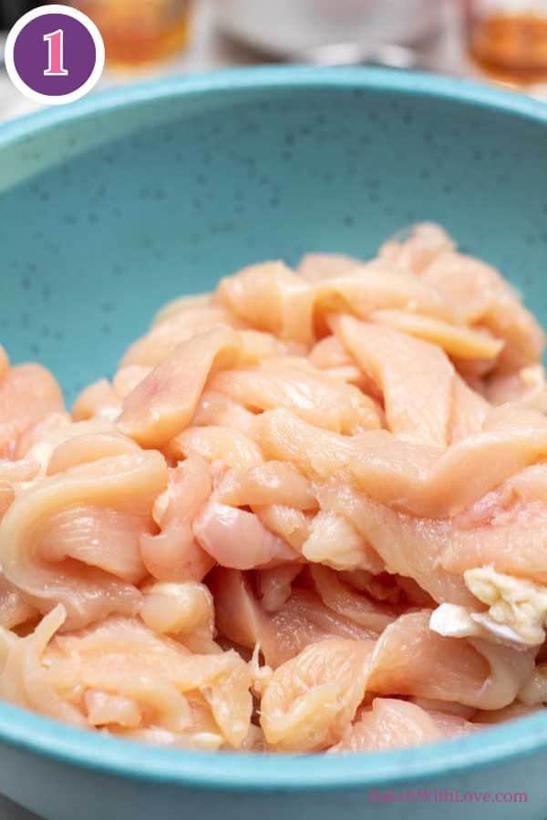 Panda Express firecracker chicken process photo 1 showing raw strips of boneless skinless chicken breast in a blue bowl.