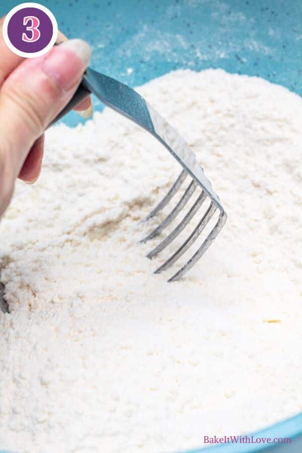Cherry chocolate chip scones process photo 3 cutting in the grated frozen butter using a pastry blender.
