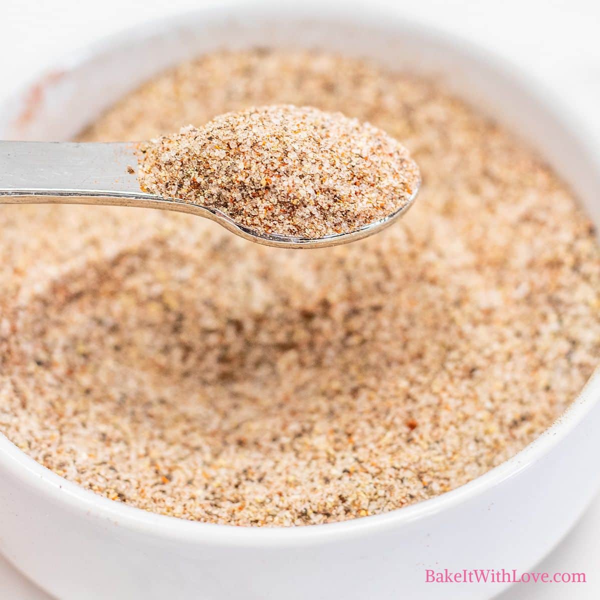 Seasoned salt mixed together in a small white bowl and ready to use in your favorite recipes.