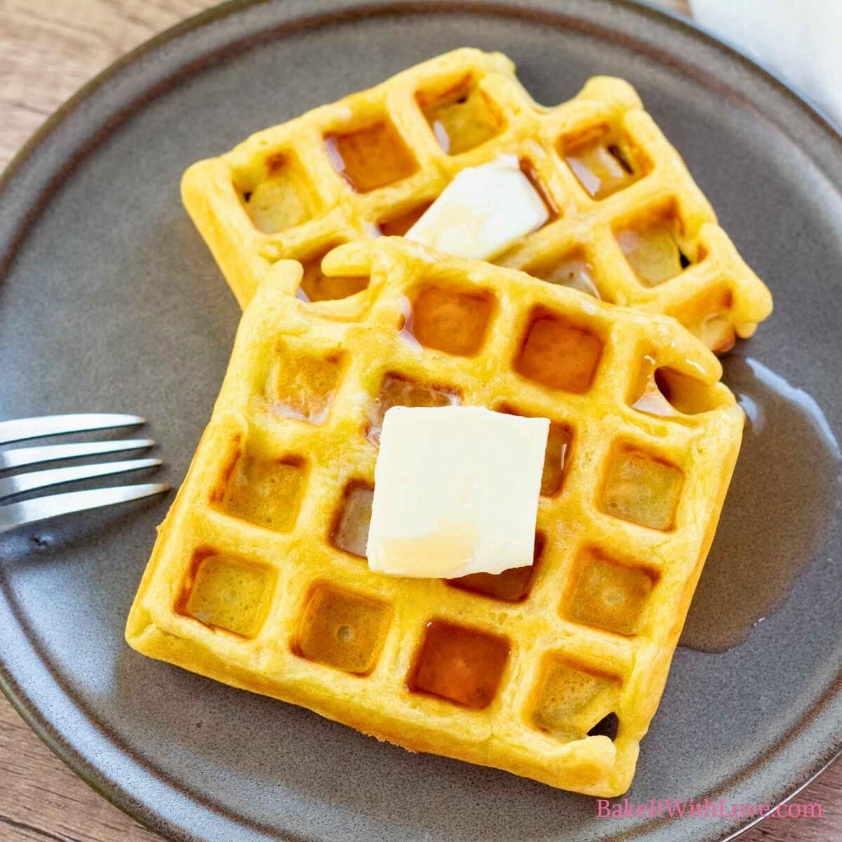 Square image showing homemade waffles on a plate.